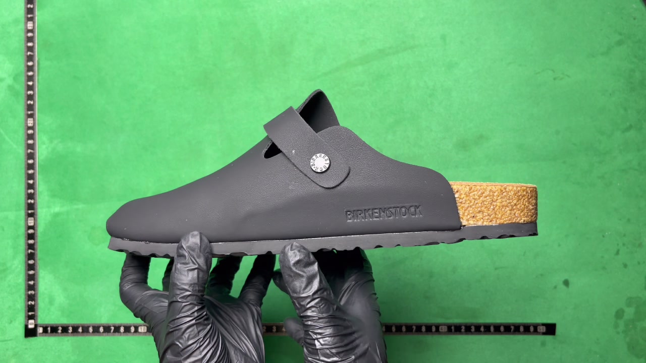 Black Birkenstock-marked clog with side logo and cork-look footbed edge