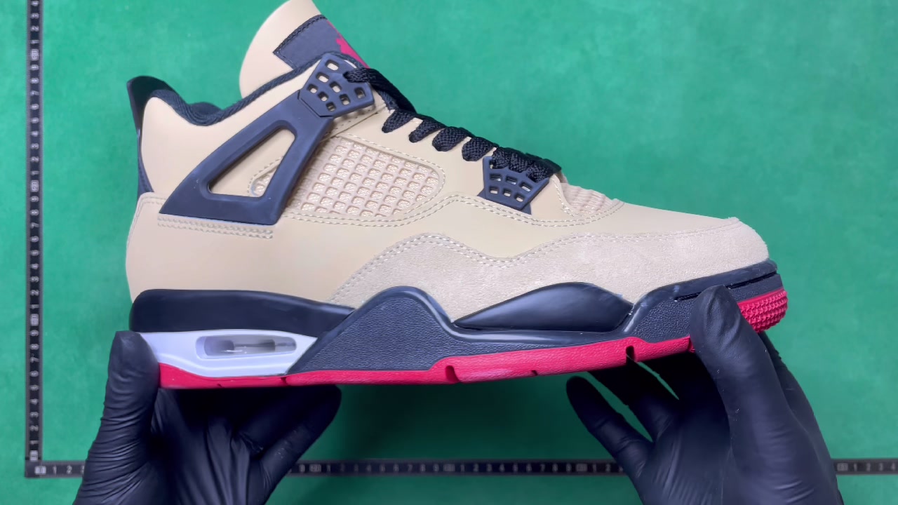 Beige, black, white, and red Jordan-marked basketball shoe