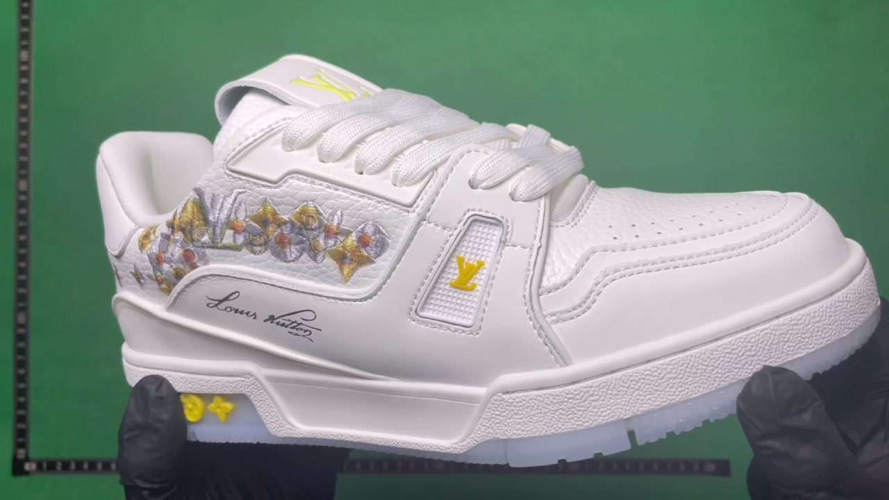 White Louis Vuitton-marked low-top sneaker with yellow and multicolor details